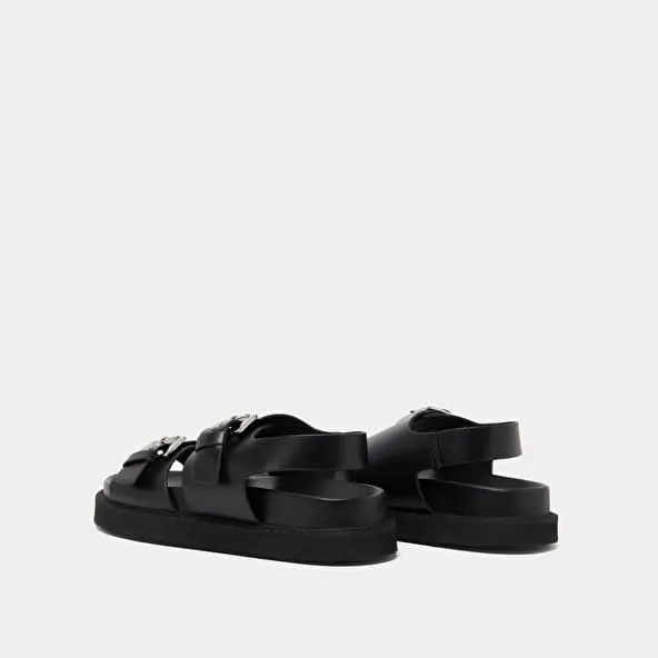 Double buckle sandals in glazed black leather